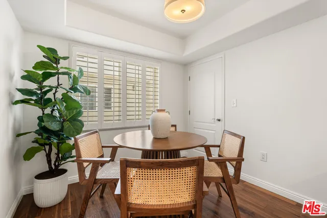 a dining room with furniture and potted plant