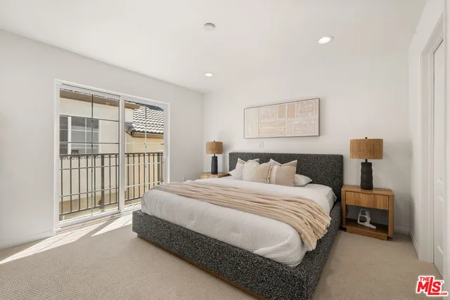 a spacious bedroom with a bed and a window