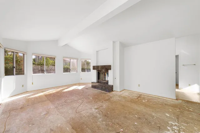 a kitchen with stainless steel appliances granite countertop a refrigerator a stove and a sink with large window