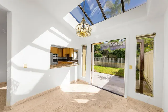 a large white kitchen with a large window