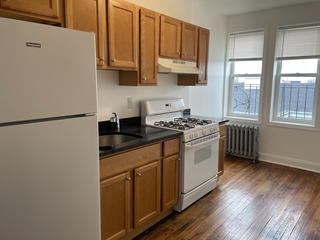 10 Yeamans Street, Unit 17A Revere, MA 02151 - Photo 1 of 6 a kitchen with stainless steel appliances granite countertop a sink a stove and a refrigerator