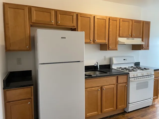 a kitchen with stainless steel appliances granite countertop a refrigerator stove a sink and dishwasher