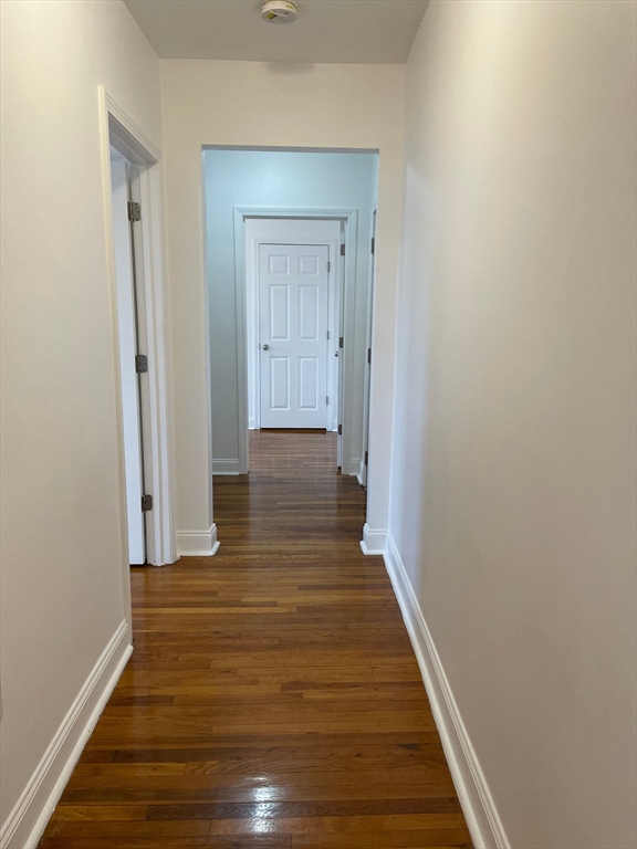 10 Yeamans Street, Unit 17A Revere, MA 02151 - Photo 3 of 6 a view of a hallway with wooden floor