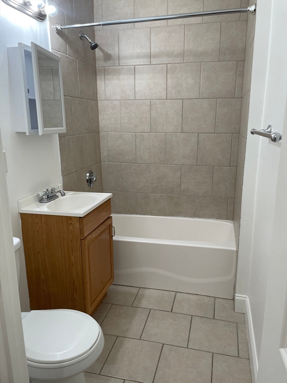 10 Yeamans Street, Unit 17A Revere, MA 02151 - Photo 5 of 6 a bathroom with a sink a toilet and shower