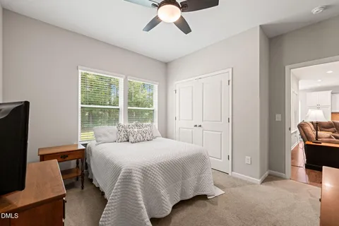 a view of a livingroom with furniture and a ceiling fan