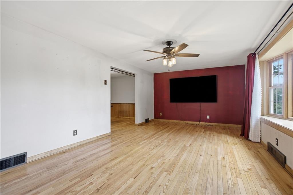 471 Beech Road Pittsburgh, PA 15239 - Photo 13 of 38 Large living room with included 85" TV. Notice the bay window!