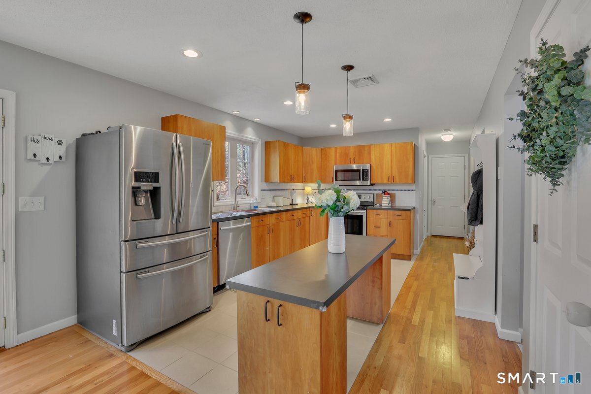 345 Hebron Road Andover, CT 06232 - Photo 3 of 39 a kitchen with stainless steel appliances granite countertop a refrigerator a oven a sink dishwasher and a refrigerator with wooden floor
