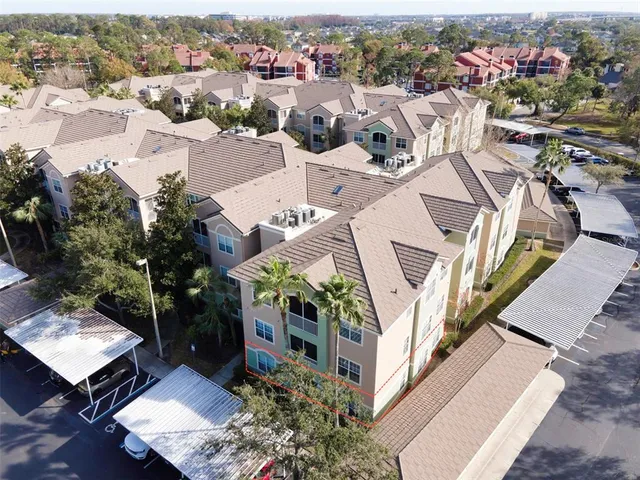 an aerial view of a house with a yard