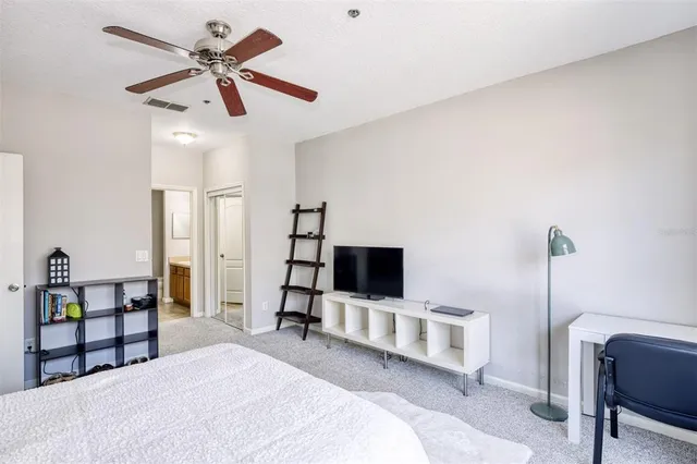 a bedroom with a bed and a chair