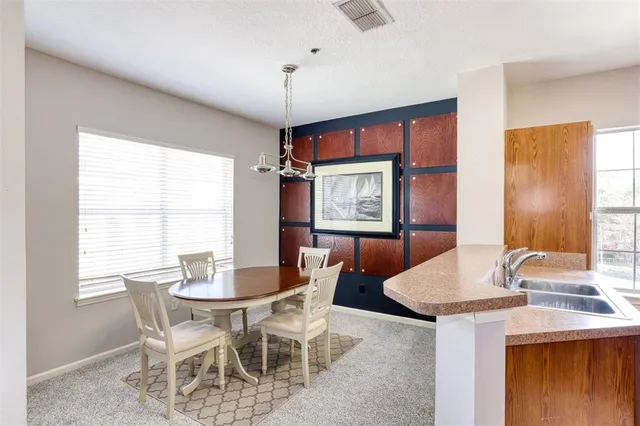 a view of a dining room with furniture and a chandelier