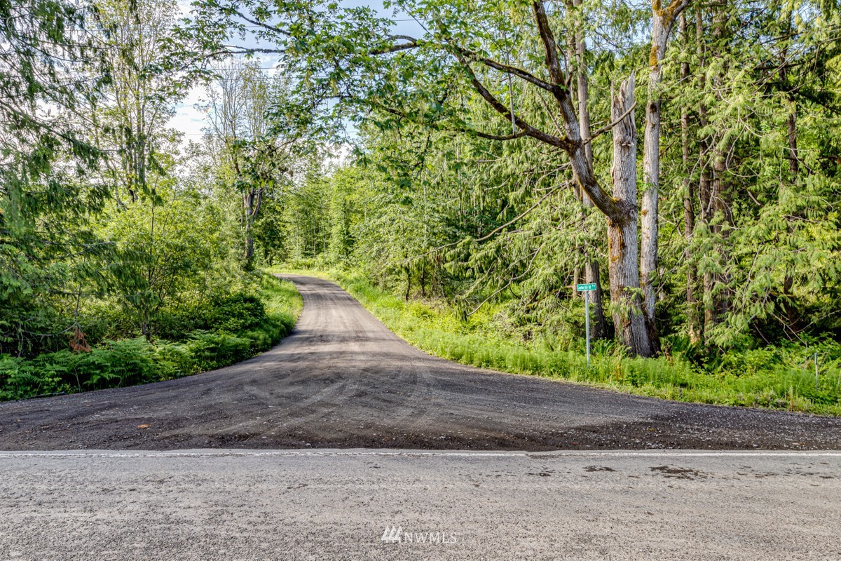 9999 Chicken Coop Road Sequim, WA 98382 - Photo 3 of 30 a view of a yard with plants and trees