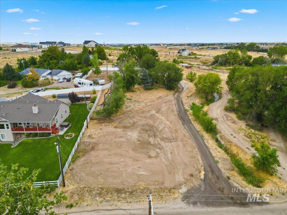 17114 Goodson Road Caldwell, ID 83607 - Photo 34 of 36 Expansive undeveloped lot with partial fencing and surrounding mature trees
