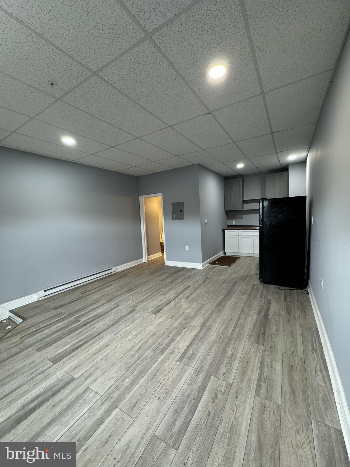 15 Church Lane, Unit 1A Lansdowne, PA 19050 - Photo 3 of 6 an empty room with wooden floor and windows