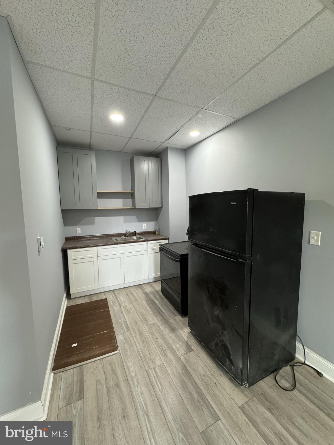 15 Church Lane, Unit 1A Lansdowne, PA 19050 - Photo 4 of 6 a kitchen with wooden cabinets and a stove