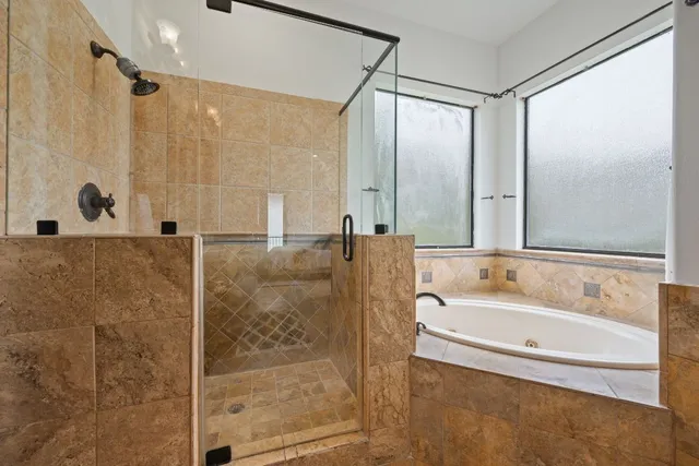 a bathroom with a bathtub and a shower