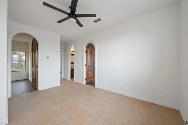 a view of a hallway with a chandelier fan