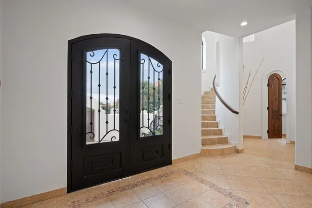 a view of a entryway door with a hallway to front door