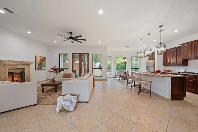 a living room with furniture and kitchen view