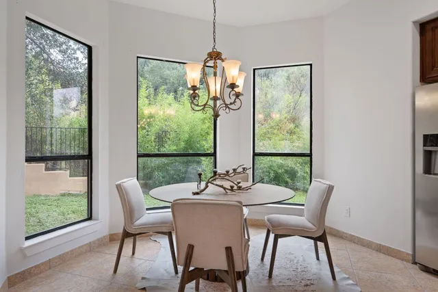 a dining room with furniture window and outside view