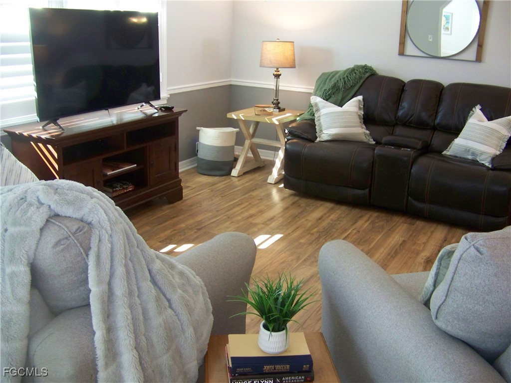 15550 Burnt Store Road, Unit 62 Punta Gorda, FL 33955 - Photo 13 of 50 a living room with furniture and a flat screen tv