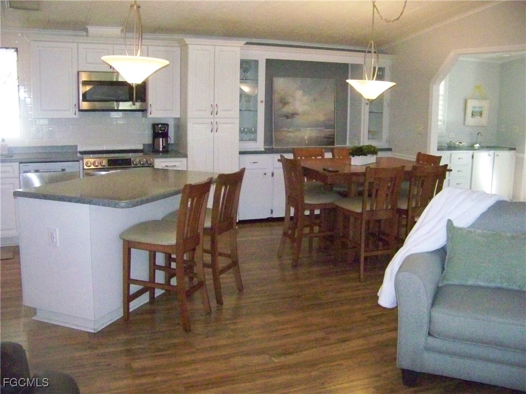 15550 Burnt Store Road, Unit 62 Punta Gorda, FL 33955 - Photo 14 of 50 a dining table chairs and a kitchen view