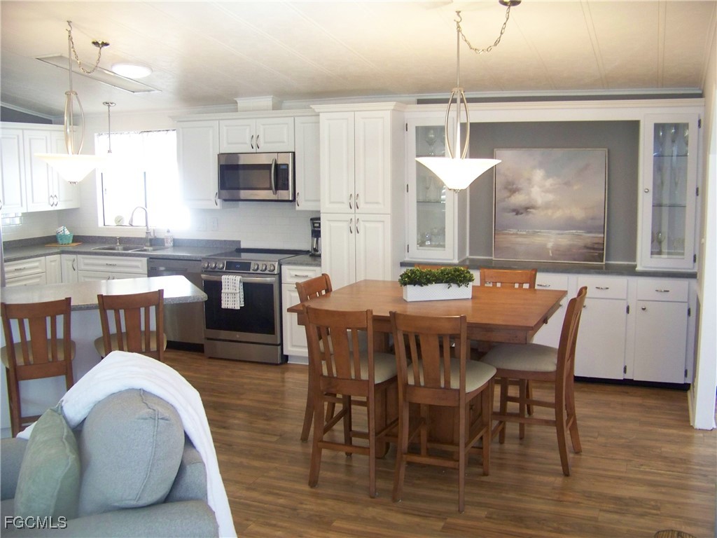 15550 Burnt Store Road, Unit 62 Punta Gorda, FL 33955 - Photo 16 of 50 a dining room with furniture and wooden floor
