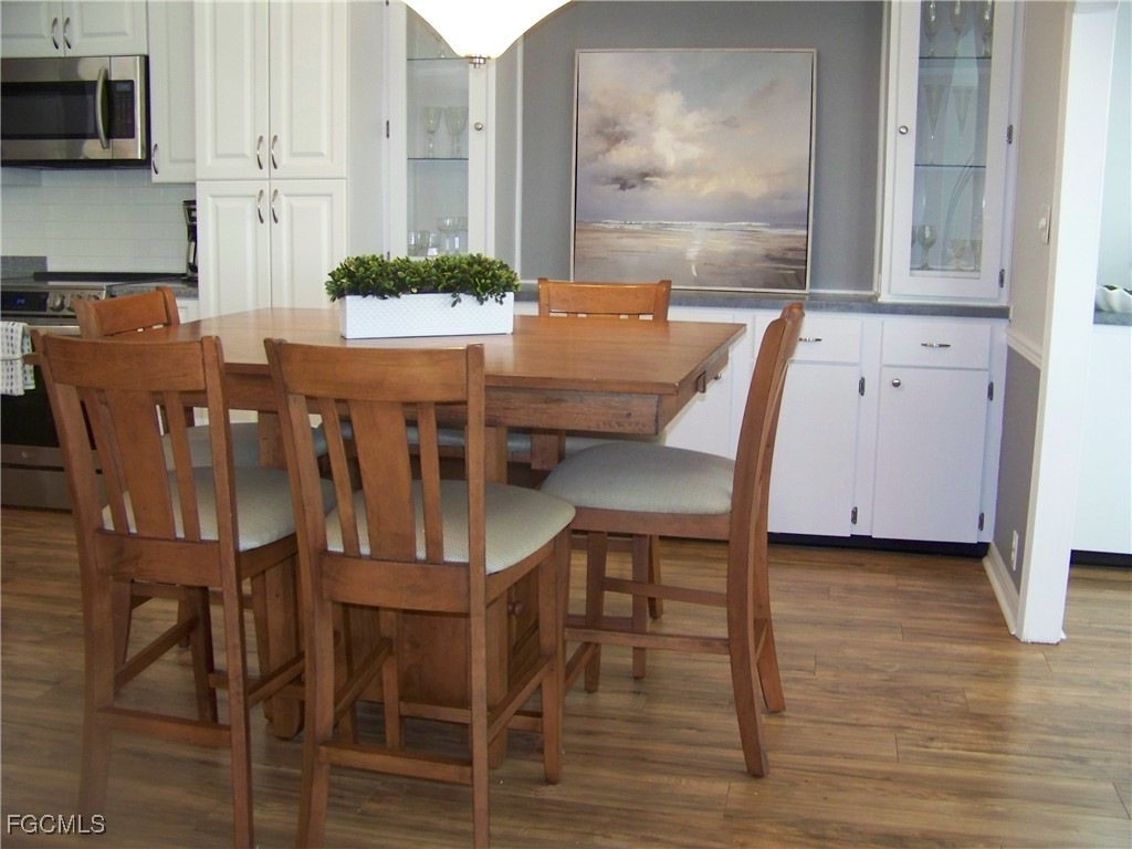 15550 Burnt Store Road, Unit 62 Punta Gorda, FL 33955 - Photo 17 of 50 a view of a dining room with furniture and wooden floor
