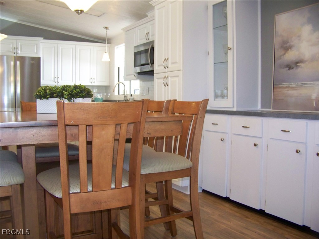 15550 Burnt Store Road, Unit 62 Punta Gorda, FL 33955 - Photo 18 of 50 a dining room with furniture and wooden floor