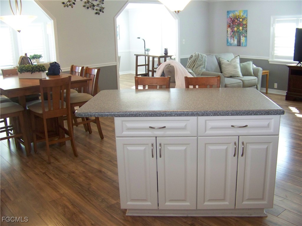 15550 Burnt Store Road, Unit 62 Punta Gorda, FL 33955 - Photo 21 of 50 a view of a dining room with furniture and wooden floor