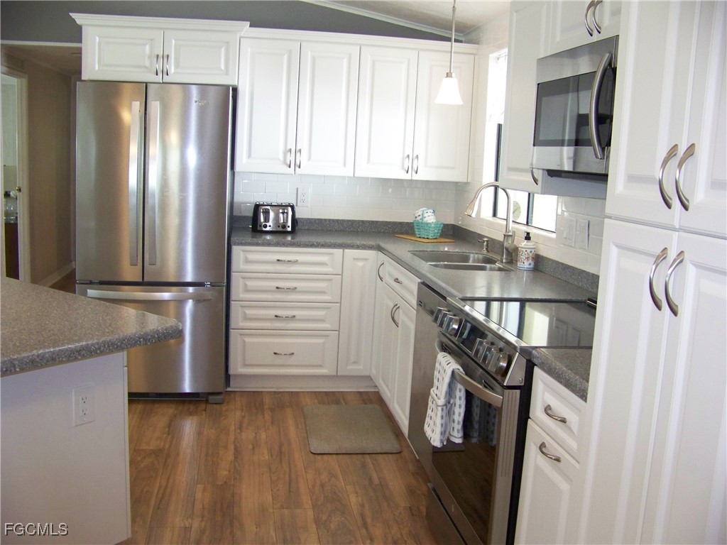 15550 Burnt Store Road, Unit 62 Punta Gorda, FL 33955 - Photo 22 of 50 a kitchen with stainless steel appliances a refrigerator sink and cabinets