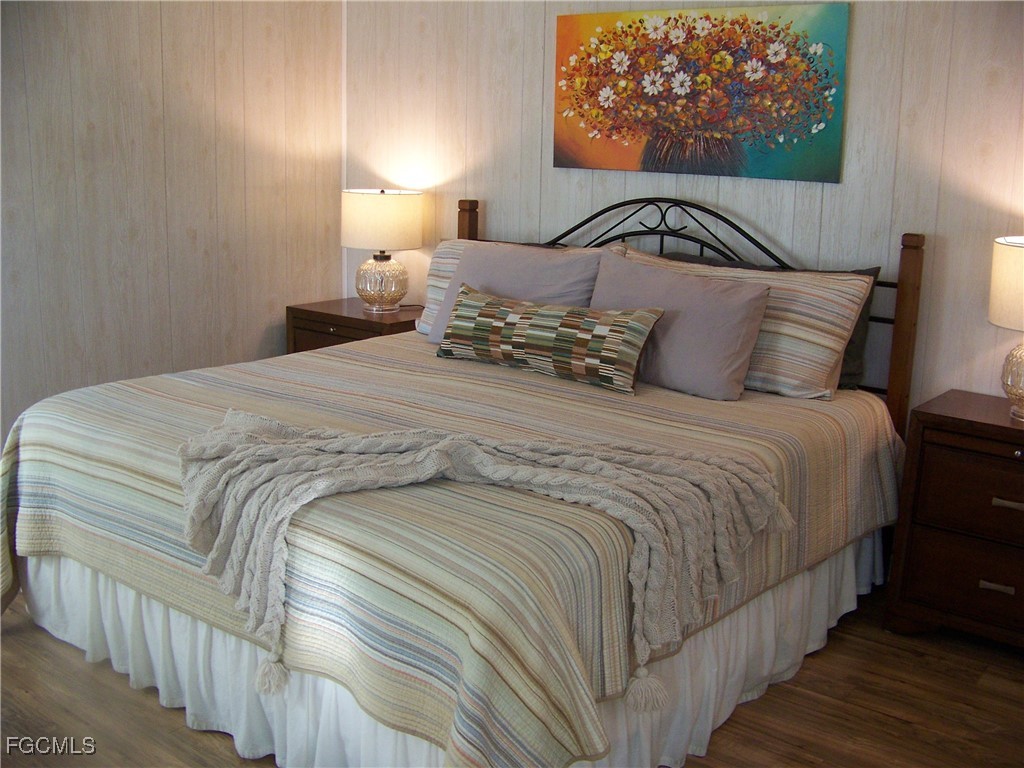 15550 Burnt Store Road, Unit 62 Punta Gorda, FL 33955 - Photo 28 of 50 a bedroom with a bed and a painting on the wall