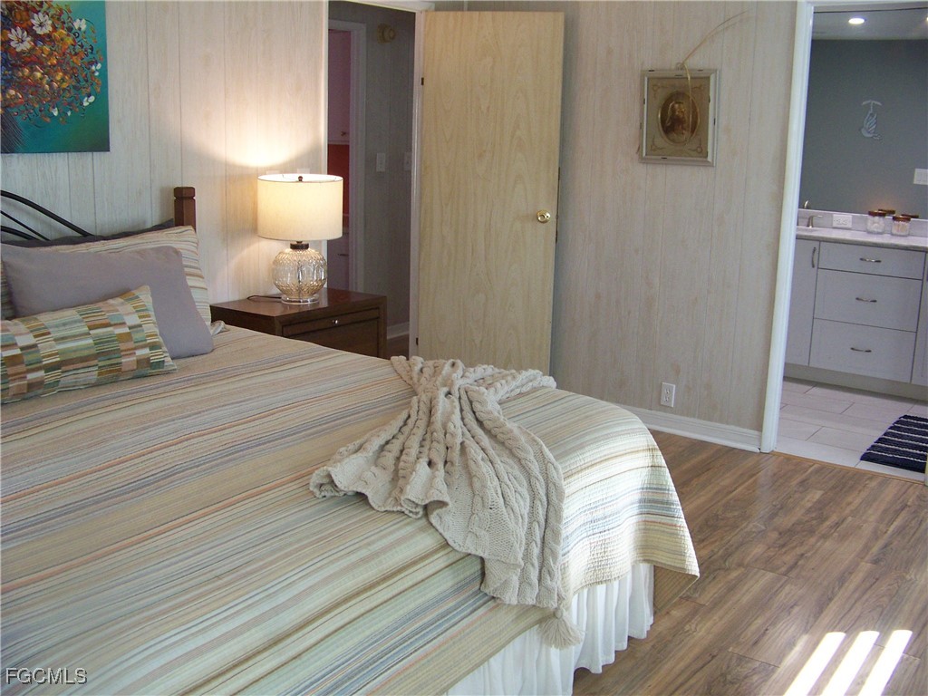 15550 Burnt Store Road, Unit 62 Punta Gorda, FL 33955 - Photo 29 of 50 a bedroom with a bed and a lamp