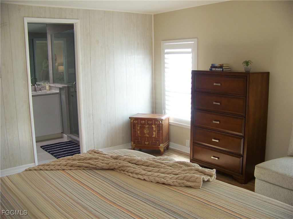 15550 Burnt Store Road, Unit 62 Punta Gorda, FL 33955 - Photo 30 of 50 a bedroom with a bed and a mirror