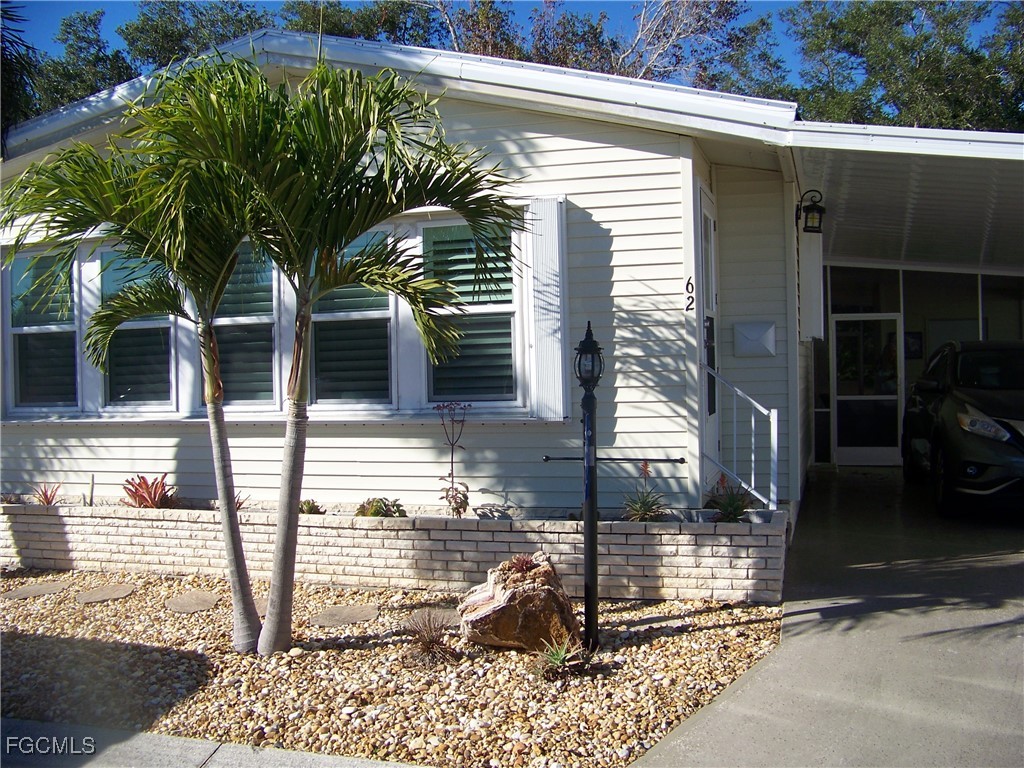 15550 Burnt Store Road, Unit 62 Punta Gorda, FL 33955 - Photo 3 of 50 a front view of a house with garden
