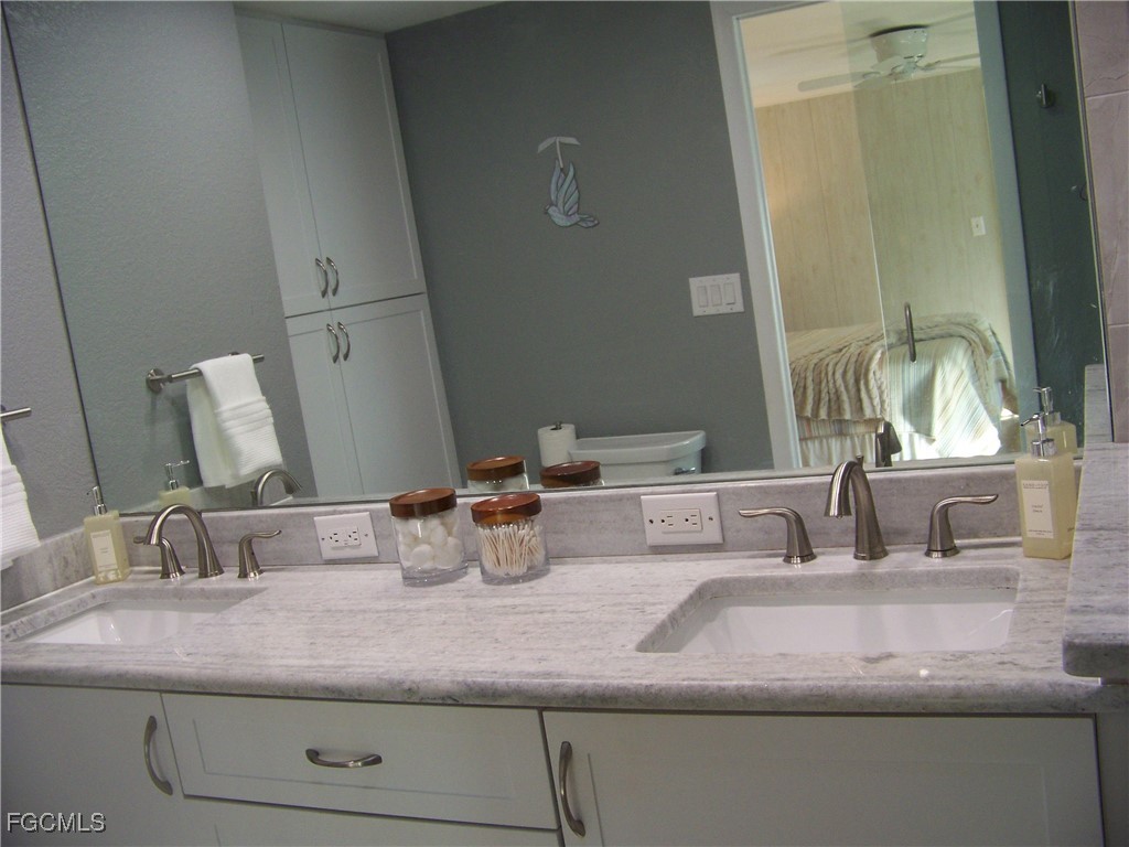 15550 Burnt Store Road, Unit 62 Punta Gorda, FL 33955 - Photo 31 of 50 a bathroom with sink and mirror