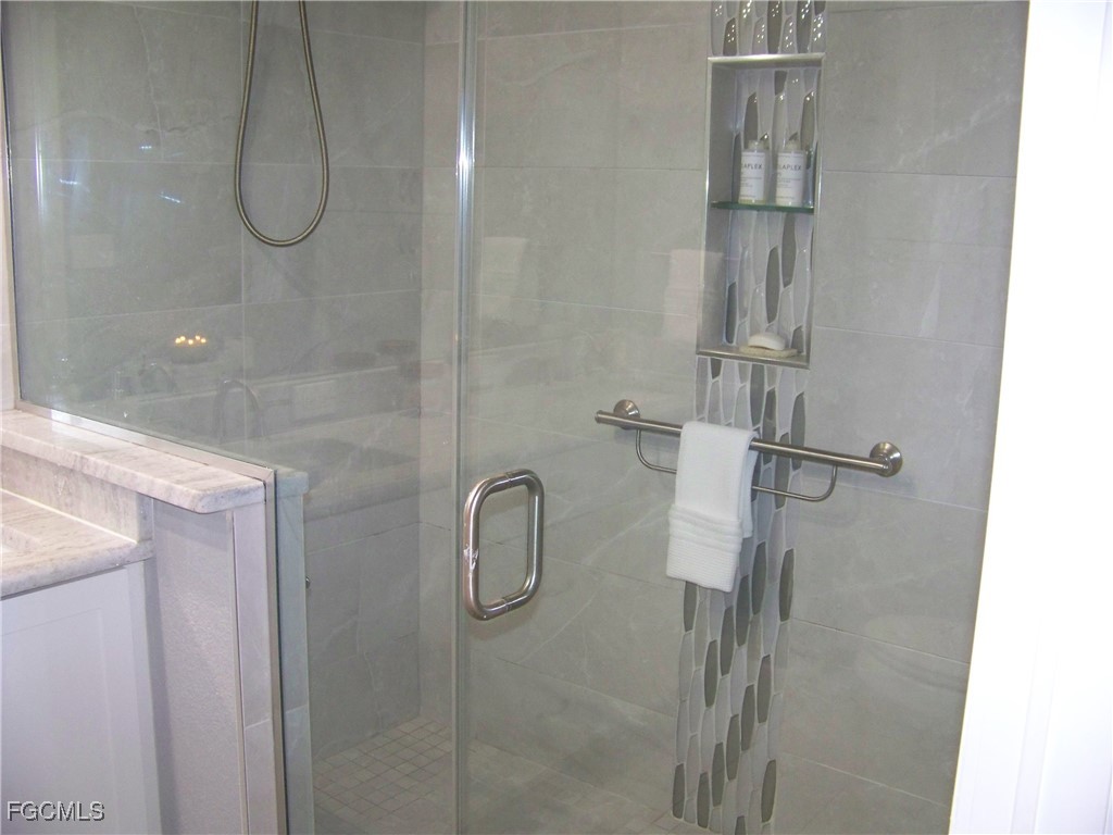 15550 Burnt Store Road, Unit 62 Punta Gorda, FL 33955 - Photo 36 of 50 a bathroom with a glass shower door