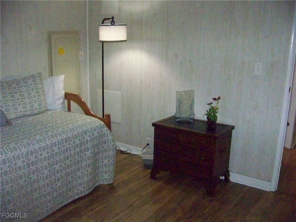 15550 Burnt Store Road, Unit 62 Punta Gorda, FL 33955 - Photo 39 of 50 a bedroom with a bed and a mirror