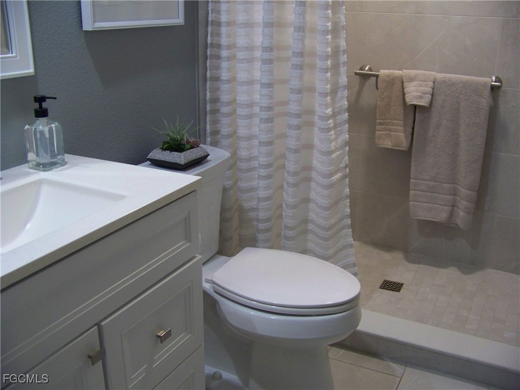 15550 Burnt Store Road, Unit 62 Punta Gorda, FL 33955 - Photo 41 of 50 a bathroom with a sink a toilet and shower