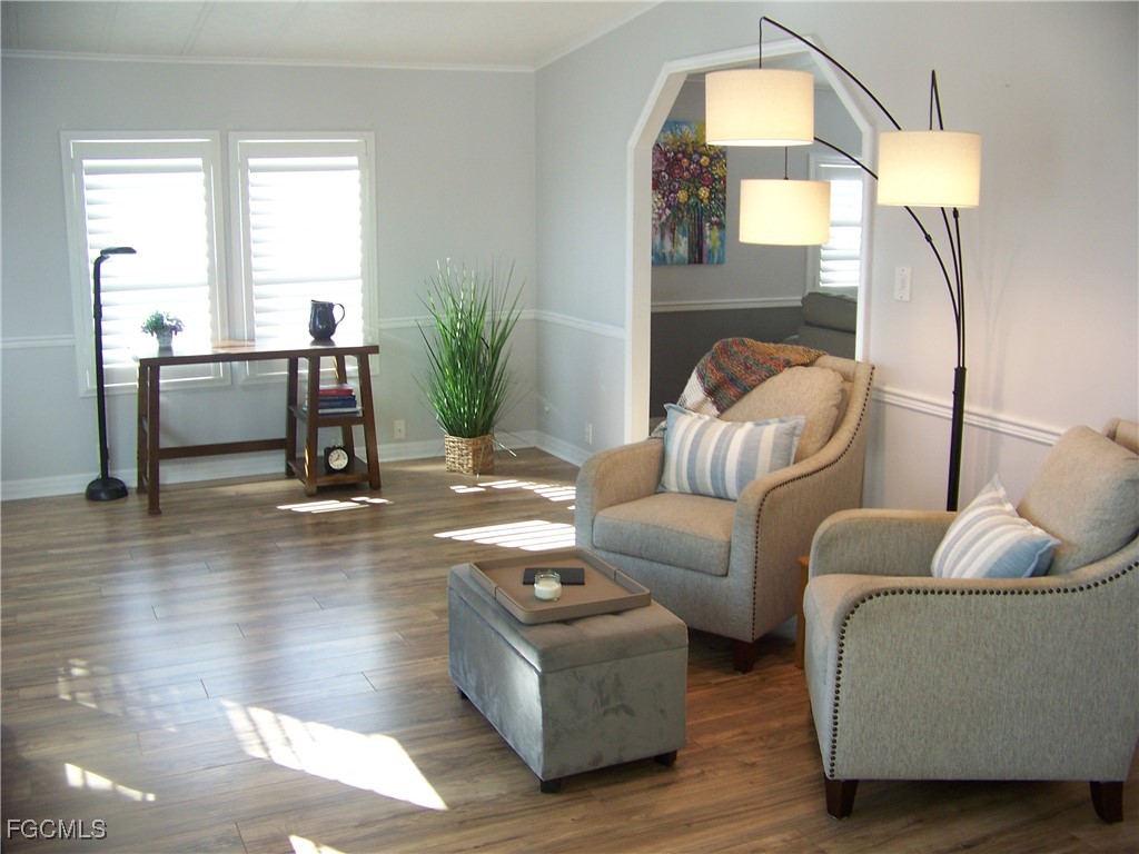 15550 Burnt Store Road, Unit 62 Punta Gorda, FL 33955 - Photo 9 of 50 a living room with furniture and a mirror