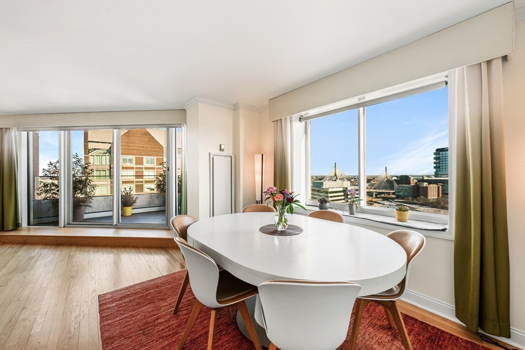 8 Museum Way, Unit 2304 Cambridge, MA 02141 - Photo 12 of 39 a dining room with furniture a chandelier and wooden floor