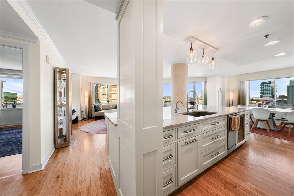 8 Museum Way, Unit 2304 Cambridge, MA 02141 - Photo 14 of 39 a large kitchen with cabinets wooden floor a sink and a stove
