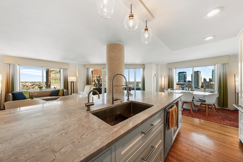 8 Museum Way, Unit 2304 Cambridge, MA 02141 - Photo 15 of 39 a kitchen with stainless steel appliances granite countertop a sink a stove and a wooden floors