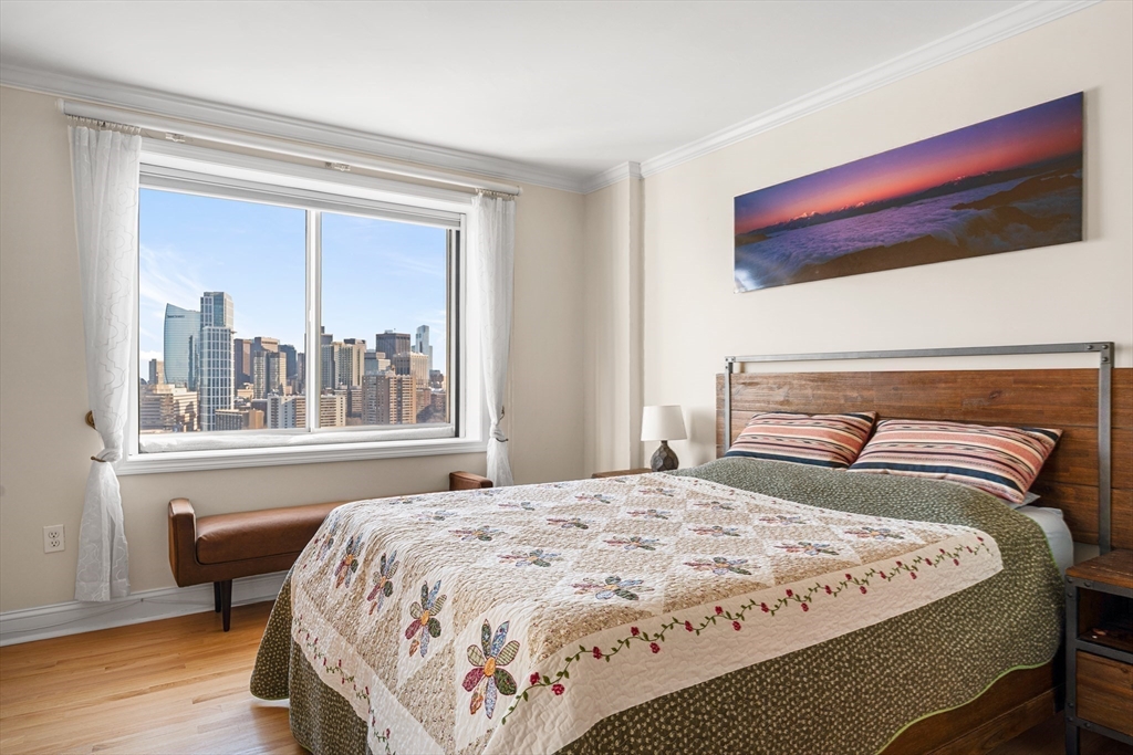 8 Museum Way, Unit 2304 Cambridge, MA 02141 - Photo 19 of 39 a bedroom with a bed and a large window