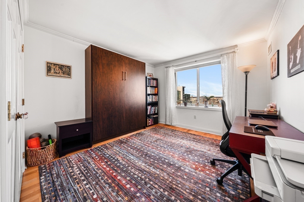 8 Museum Way, Unit 2304 Cambridge, MA 02141 - Photo 22 of 39 a bedroom with a bed and a dresser in it