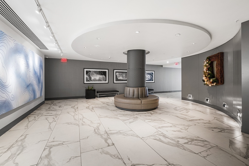 8 Museum Way, Unit 2304 Cambridge, MA 02141 - Photo 26 of 39 a living room with furniture and a flat screen tv