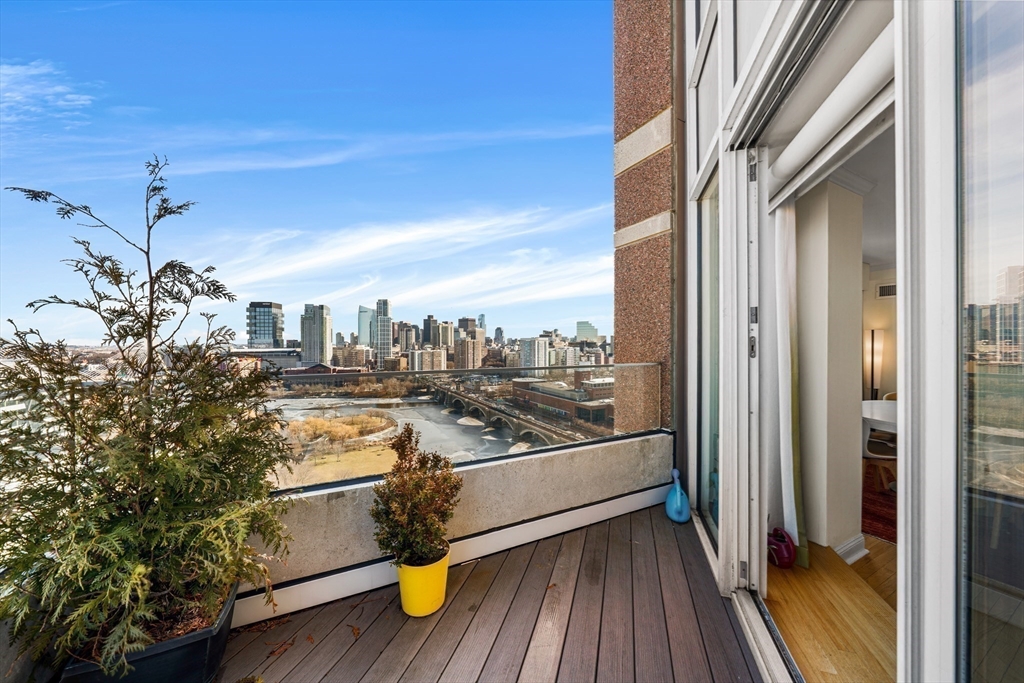 8 Museum Way, Unit 2304 Cambridge, MA 02141 - Photo 5 of 39 a view of a balcony with wooden floor and iron stairs