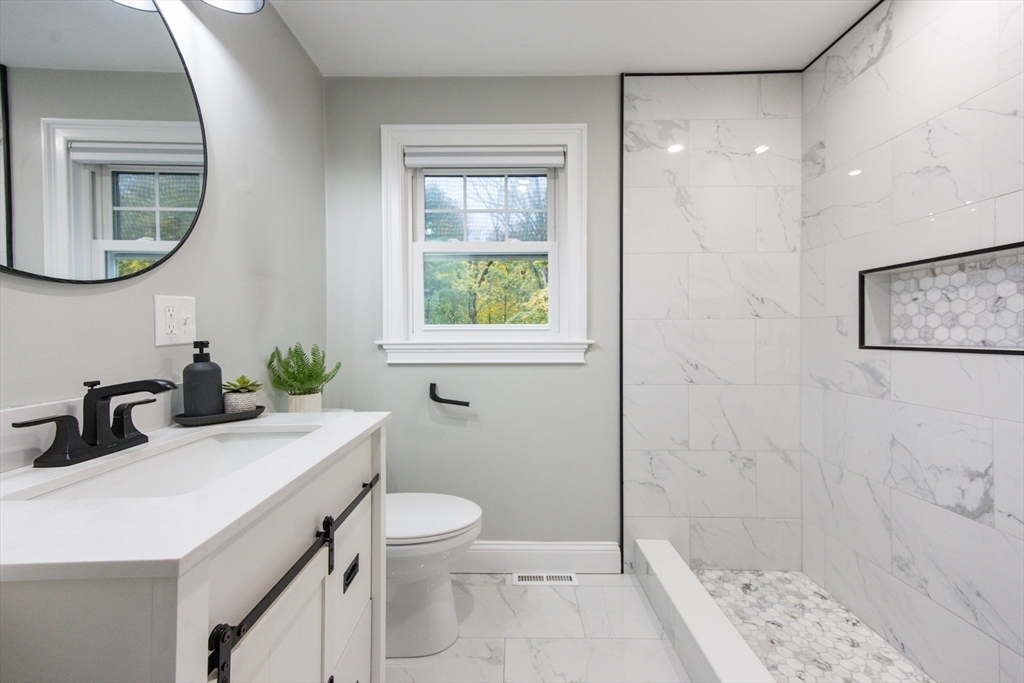 841 Lincoln Street Franklin, MA 02038 - Photo 12 of 25 a bathroom with a sink a toilet and shower