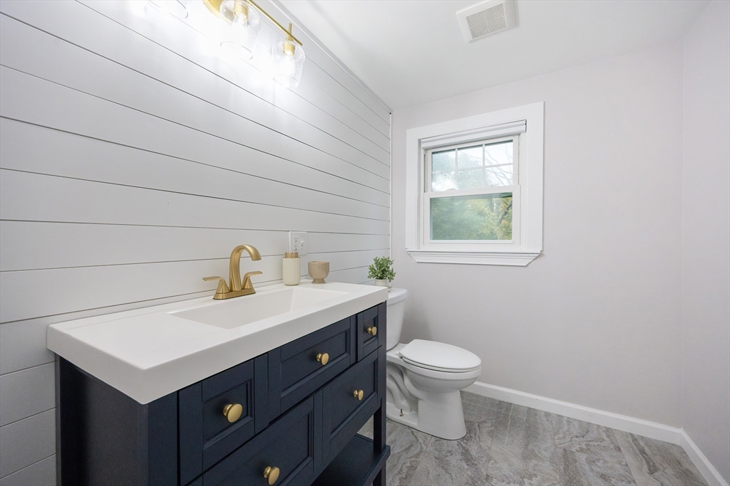 841 Lincoln Street Franklin, MA 02038 - Photo 20 of 25 a bathroom with a sink a toilet and a window
