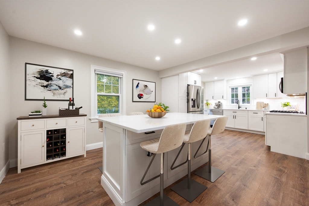841 Lincoln Street Franklin, MA 02038 - Photo 3 of 25 a kitchen with a table chairs refrigerator and cabinets
