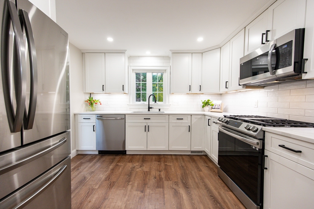 841 Lincoln Street Franklin, MA 02038 - Photo 5 of 25 a kitchen with appliances cabinets and a sink